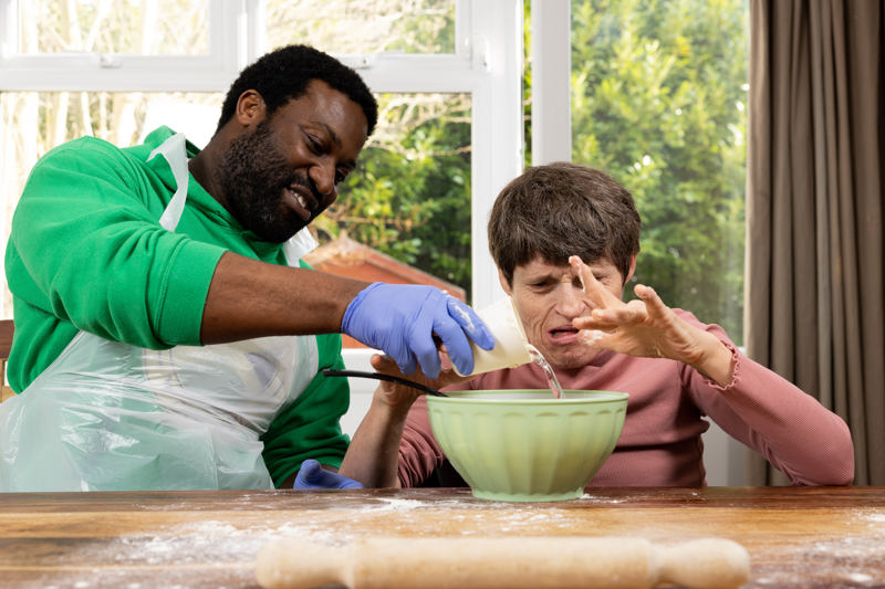 Baking together with a mixing bowl at a flour-dusted table at Westholme