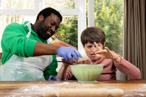 Baking together with a mixing bowl at a flour-dusted table at Westholme