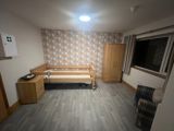 Bedroom at Byron Lodge with a profiling bed, wardrobe and bedside drawers