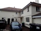 Rear exterior of Chepstow House, a cream two-storey building with parked cars and a tarmac driveway