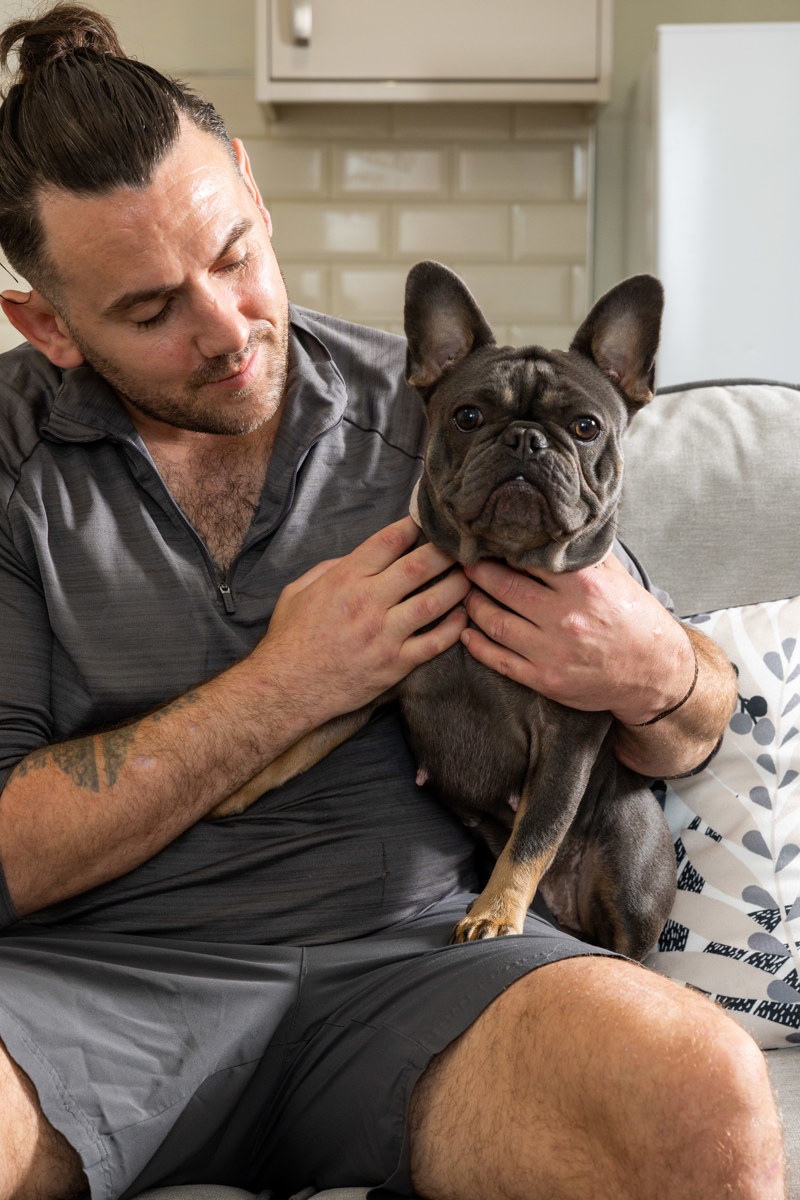 Holding a pet French bulldog in the kitchen at Trevelyan