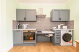 Accessible kitchen at Church Road with grey units, a height-adjustable hob and sink