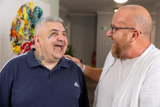 Two men sharing a laugh together in a communal lounge at Eilat