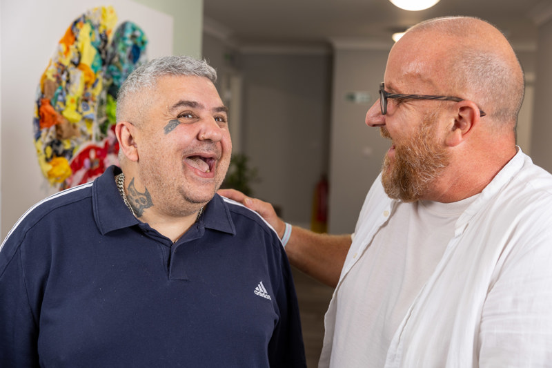 Two men sharing a laugh together in a communal lounge at Eilat