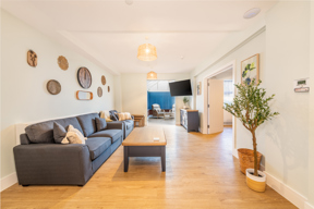 Lounge at Church Road with grey sofas, a coffee table and a conservatory beyond