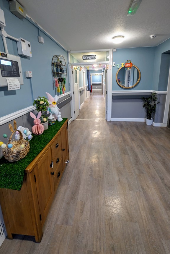 Entrance corridor at Cedar House with a Welcome to Cedar House sign and seasonal decorations