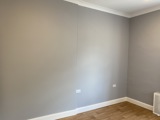Unfurnished bedroom at Cranwell Court with grey walls and wood-effect flooring