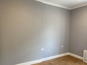 Unfurnished bedroom at Cranwell Court with grey walls and wood-effect flooring