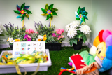 Brightly coloured toys and plants on a bright green surface