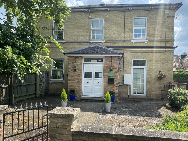 Yellow-brick frontage of Cranwell Court with its entrance porch, planters and front garden