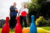 Two people playing garden skittles on the lawn at Brookside Avenue East