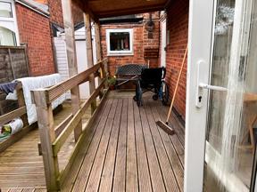 Wheelchair-accessible timber decked ramp with handrails at the rear of Chesterwood