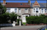 Street view of Thompson Court, a mid-terrace house with a tiled roof, bay window and front garden