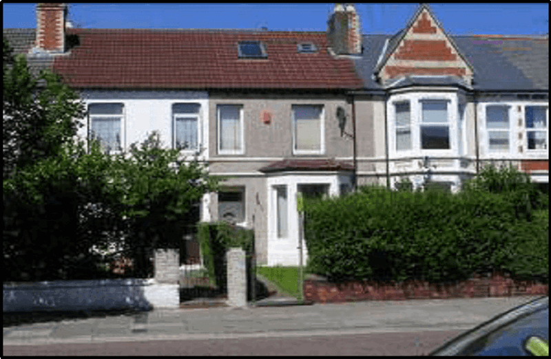 Street view of Thompson Court, a mid-terrace house with a tiled roof, bay window and front garden