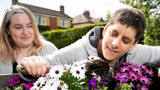 Planting a window box of flowers in the front garden at Westholme