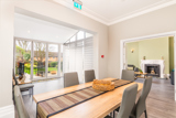 Dining room at Bayview Lodge with a wooden table and patio doors opening onto the garden
