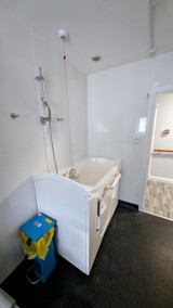 Bathroom at Cedar House with a walk-in bath and overhead shower