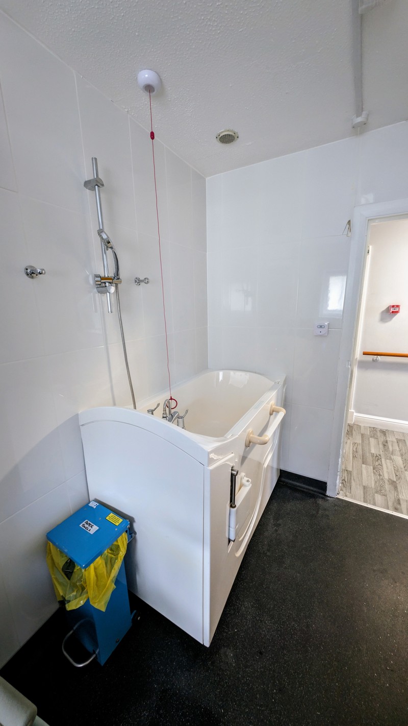Bathroom at Cedar House with a walk-in bath and overhead shower