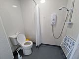 Wet room at Chesterwood with a level-access shower, fold-down seat and grab rails