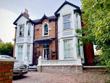 Victorian style double fronted 2 story home built with red brick .