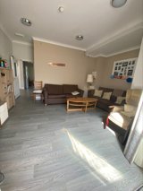 Lounge at Eilat with brown sofas, a round wooden coffee table and grey wood-effect flooring