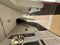 Entrance hallway at Glanmore with a stained glass front door, staircase and wood-effect flooring