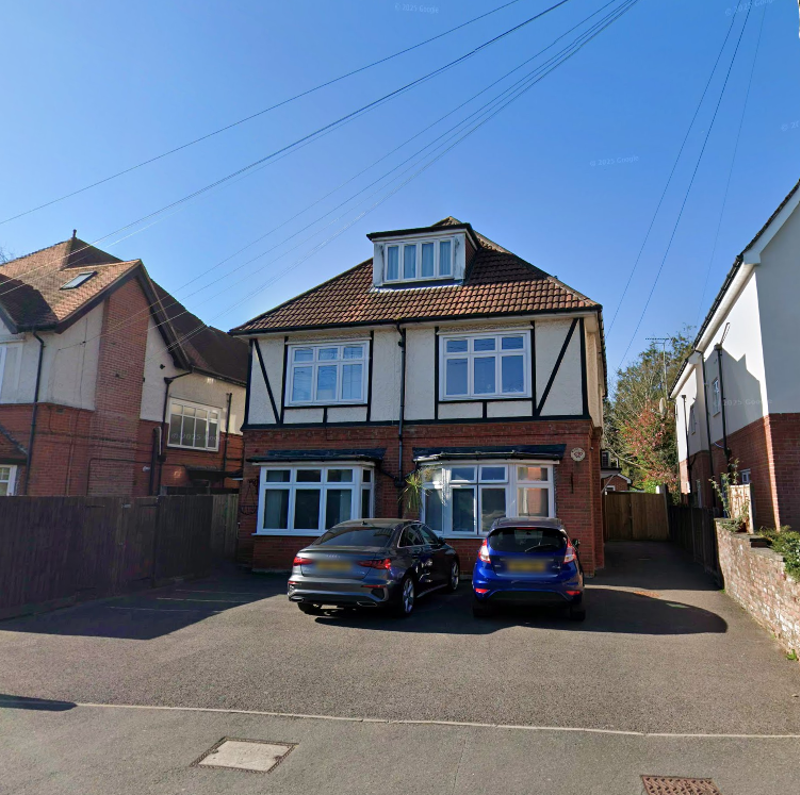 Street view of Eilat, a detached mock-Tudor house with cars parked on the front drive