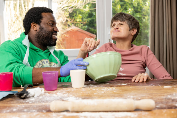 Baking activity at a flour-dusted kitchen table at Wyboston Lodge with a green mixing bowl and rolling pin