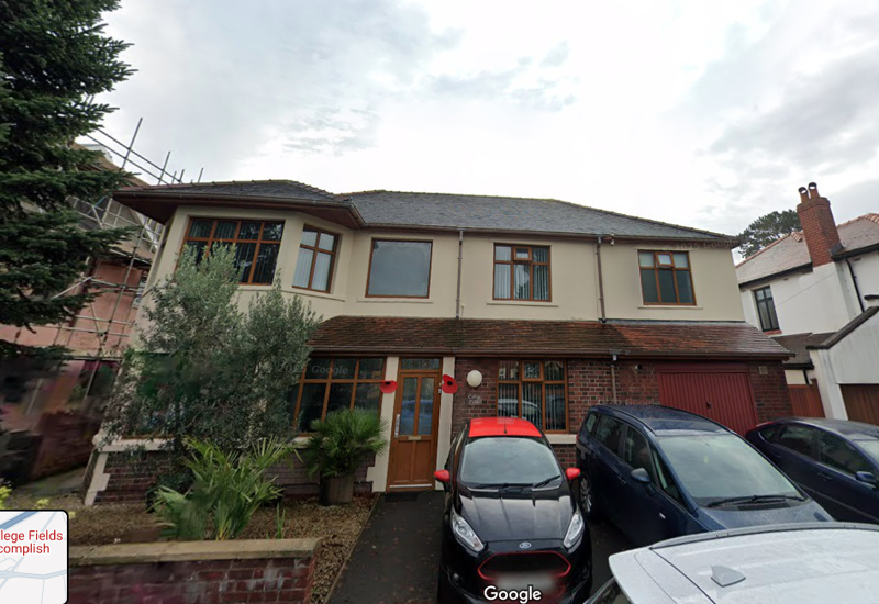 Street-view exterior of College Fields, a large detached house with cars parked on the driveway