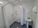 Accessible wet room at Chesterwood with a level-access shower, shower seat and basin