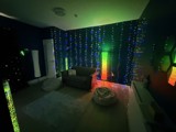 Sensory room at Manor Farm with fibre-optic light curtains, a sofa and bean bags