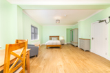 Spacious bedroom at Church Road with a wooden bed, wardrobe and mint green walls