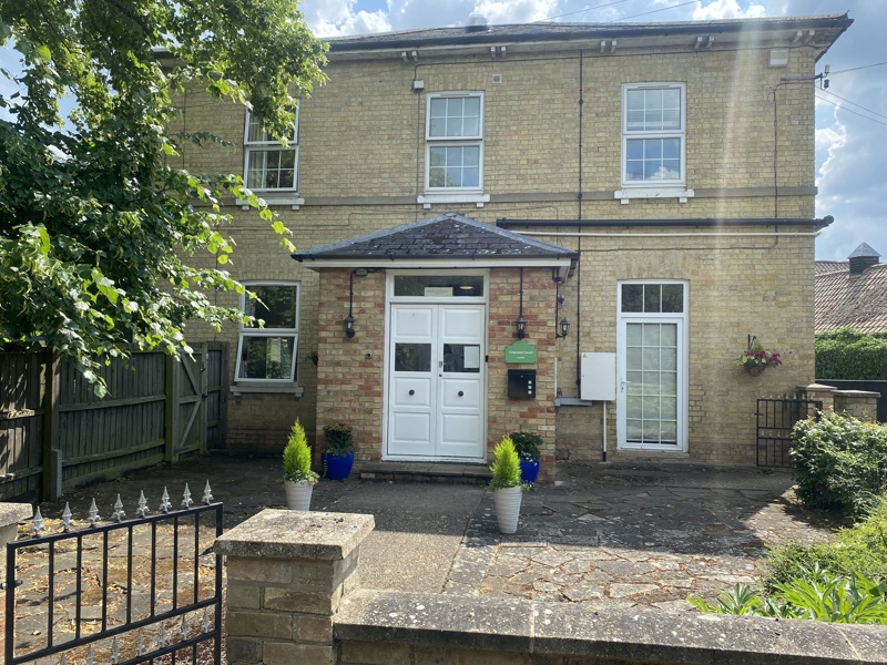 Front exterior of Cranwell Court, a yellow-brick two-storey house with white double doors and a porch