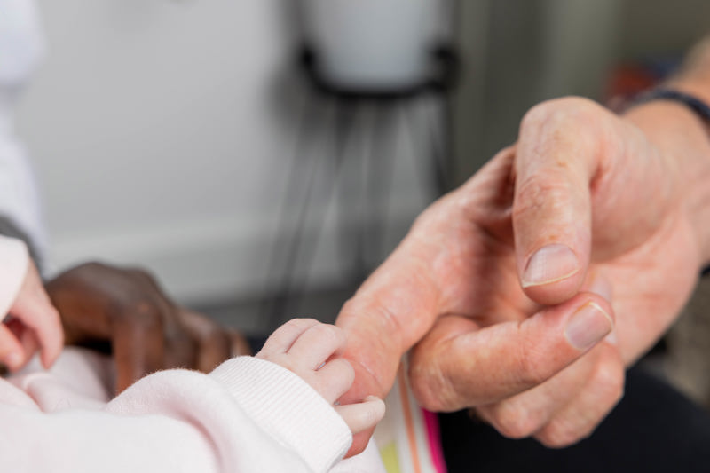 Newborn baby's hand gripping an adult's finger at Clairmont family assessment centre